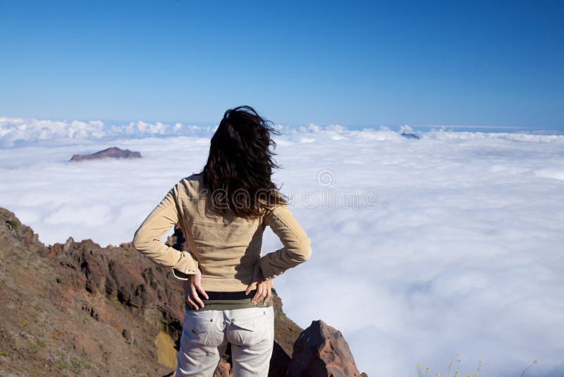 Back woman over fog ocean