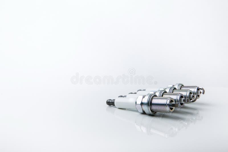 Backdrop with set of spark plugs on white background with copy space. stock images Backdrop with set of spark plugs on white background with copy space. stock images