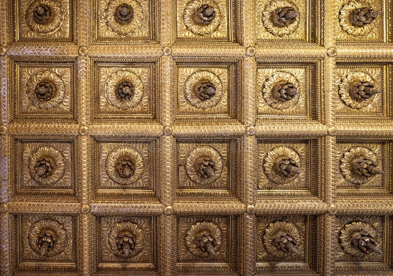 Geometrical squares with central decoration golden plaster ceiling from historical Palace in Caserta, Italy