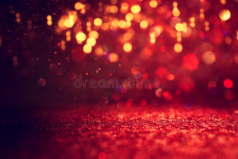 Background of Abstract Red, Gold and Black Glitter Lights. Defocused