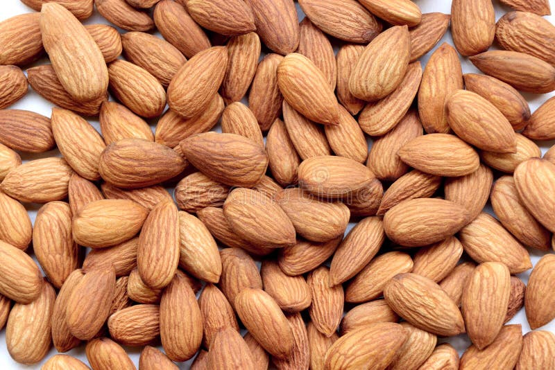 Background of big raw peeled almonds situated arbitrarily stock photo