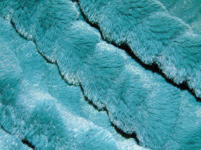 Background of blue faux fur, fabric, sewing, dress, fashion. Wallpaper of closeup of blue faux fur, fabric. Detail of beautiful shiny blue faux fur, fashion stock photos