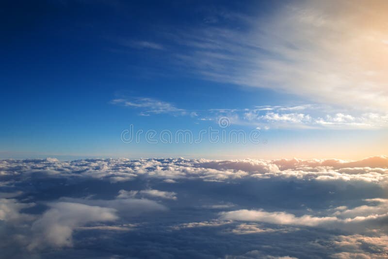 Background of blue sky over cumulus clouds with the rays of the setting sun. royalty free stock photography Background of blue sky over cumulus clouds with the rays of the setting sun. royalty free stock photography