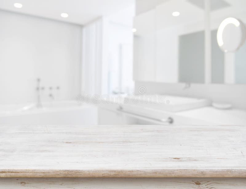 Background of Blurred Bathroom Interior with Wooden Table in Front