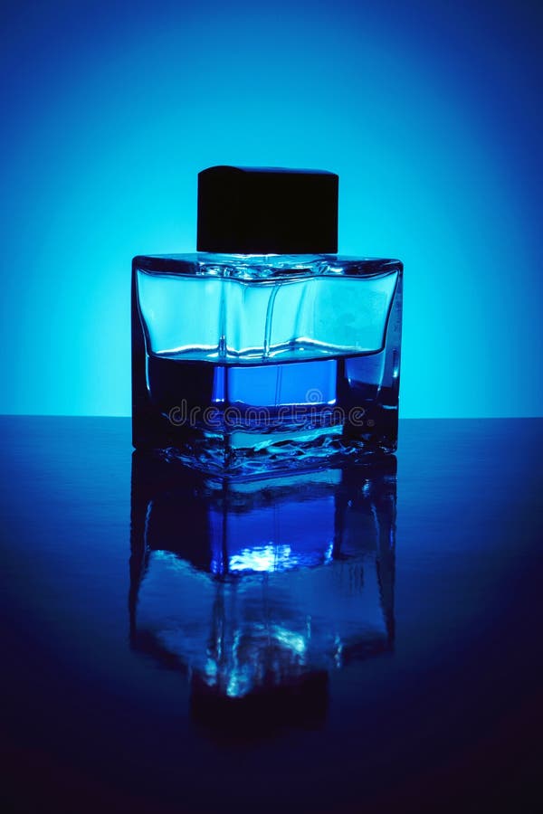 Background with Bottle of Perfume with Blue Liquid, Backlit. Stock