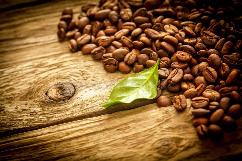 Background of coffee beans on rustic driftwood royalty free stock photos Background of coffee beans on rustic driftwood royalty free stock photos