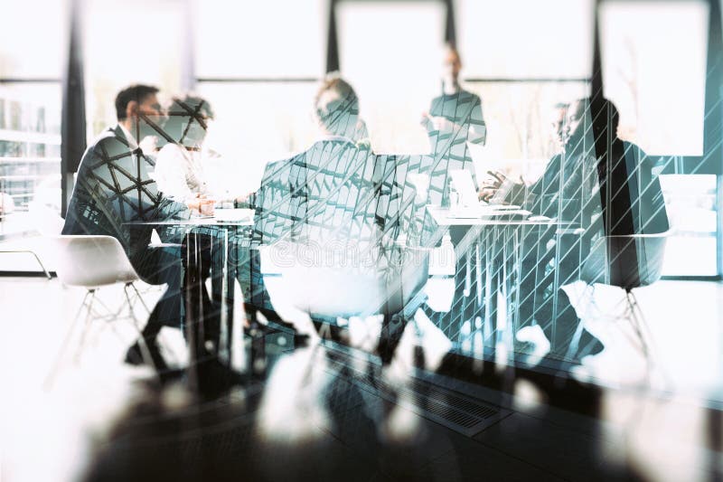 Background concept with business people sitting at the meeting table in the office near a window glass. Double exposure stock images Background concept with business people sitting at the meeting table in the office near a window glass. Double exposure stock images