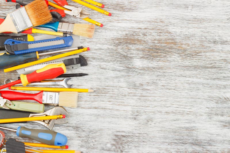 Different Construction Tools on the Wooden Background Stock Photo