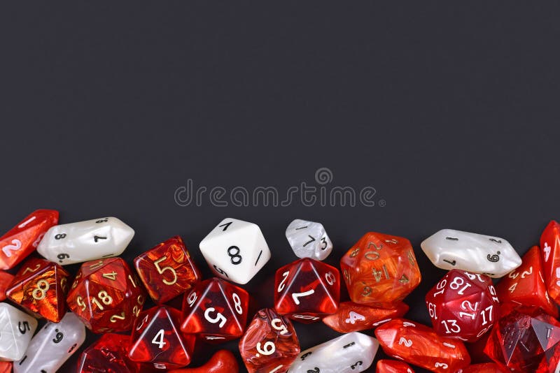 Background with different roleplaying RPG dice at bottom of dark black background with blank copy space