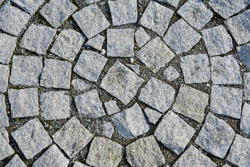Background Fragment of an Old Sidewalk Paved with Granite Paving