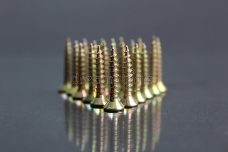 Background, group, pattern, shiny, texture, object, macro, work, metal, equipment, head, small, construction, steel, industrial, photo, iron, repair, screw, black, screws, closeup, technology, mirroring, industry, tool, metallic, part, chrome, engineering, design, abstract, row, arranged, graphic, light, concept, bright, reflection, set, golden, shadow, fthread, tools, mechanic. Mirroring object stock images, royalty-free photos and pictures