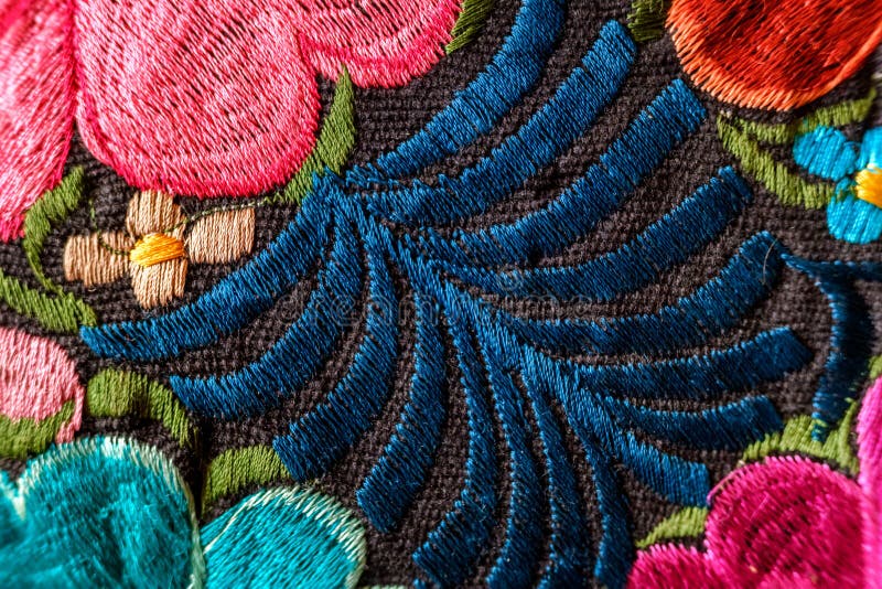 Background of Handembroidered Flowers on a Fabric with Colored Threads