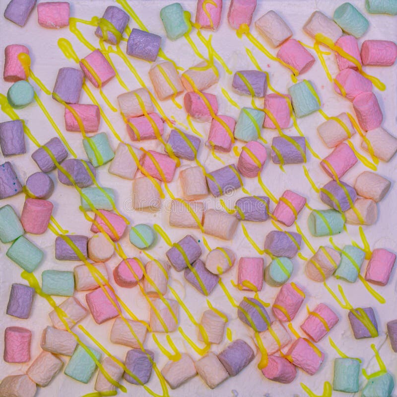 Background of multicolor four layer cake with colored marshmallow on the top. Close up. Rainbow cake texture royalty free stock photography