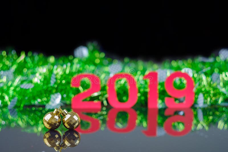 Closeup double golden circle ornaments on reflex floor with background of new year 2019