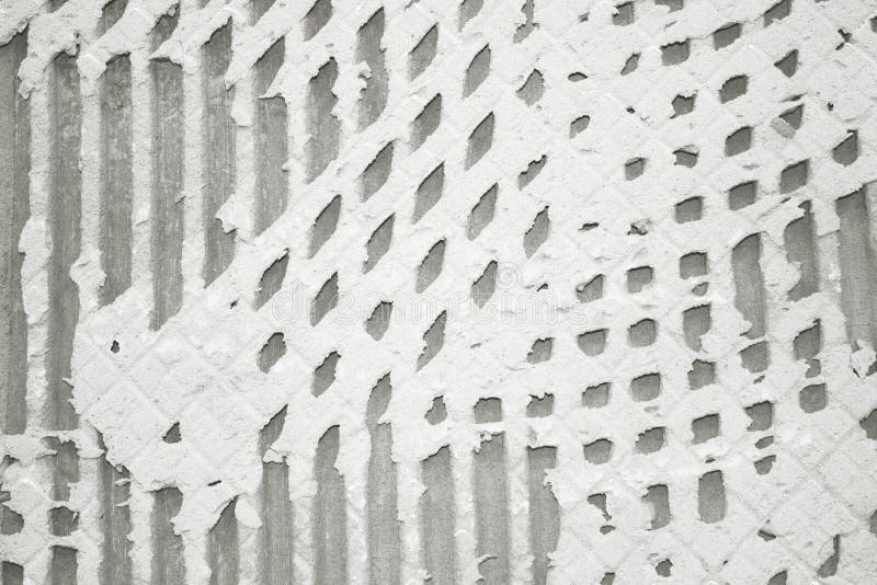 Background of Old Tile Adhesive on Wall, Pattern of Notched Trowel