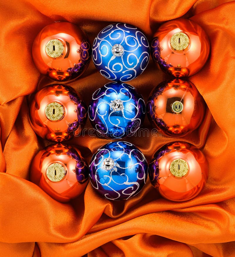 Background of orange and blue Christmas tree balls on orange silk fabric stock photos Background of orange and blue Christmas tree balls on orange silk fabric stock photos