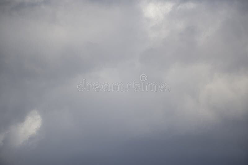 Background of real heavy clouds. Background summer sky. Gray background. Gray sky background with tiny clouds royalty free stock images