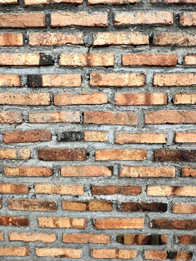 Background of a red brick. With uneven surface. Stone cladding wall background stock images
