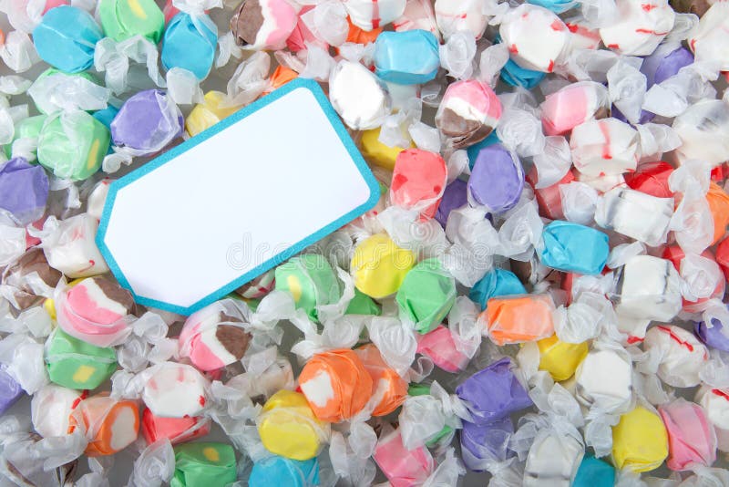 Background of salt water taffy in various flavors and colors with blank note card royalty free stock image Background of salt water taffy in various flavors and colors with blank note card royalty free stock image
