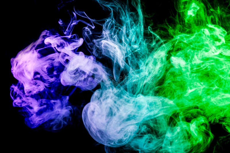 Dense multicolored smoke of blue and green colors on a black isolated background. Background of smoke vape. Dense multicolored smoke of blue and green colors on a black isolated background. Background of smoke vape