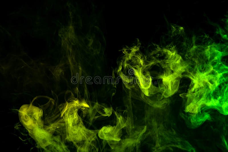 Textural background for creativity . Dense multicolored smoke of green and yellow colors on a black isolated background. Background of smoke vape. Textural background for creativity . Dense multicolored smoke of green and yellow colors on a black isolated background. Background of smoke vape