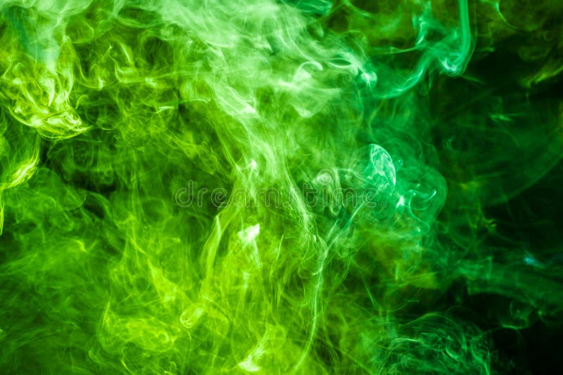 Thick colorful smoke of green on a black background. Background from the smoke of vape