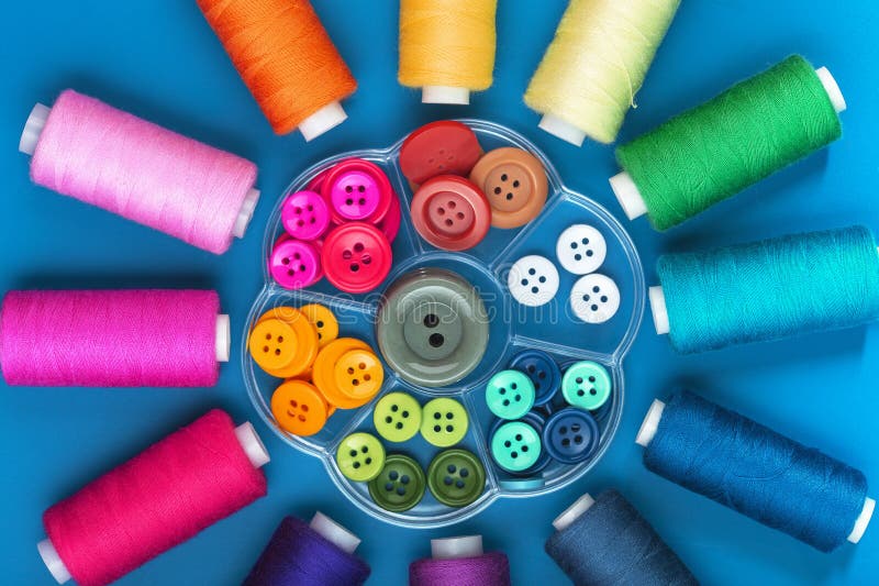 Background from Spools of Sewing Threads and Buttons of Different