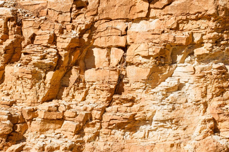 Background stone texture. Yellow rock wall