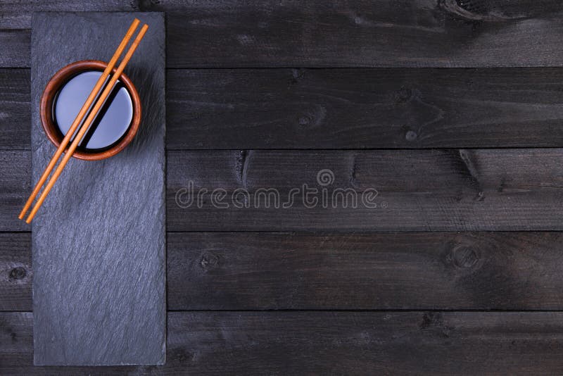 Background for sushi. Soy sauce, chopsticks on black table. Top view with copy space stock photography Background for sushi. Soy sauce, chopsticks on black table. Top view with copy space stock photography