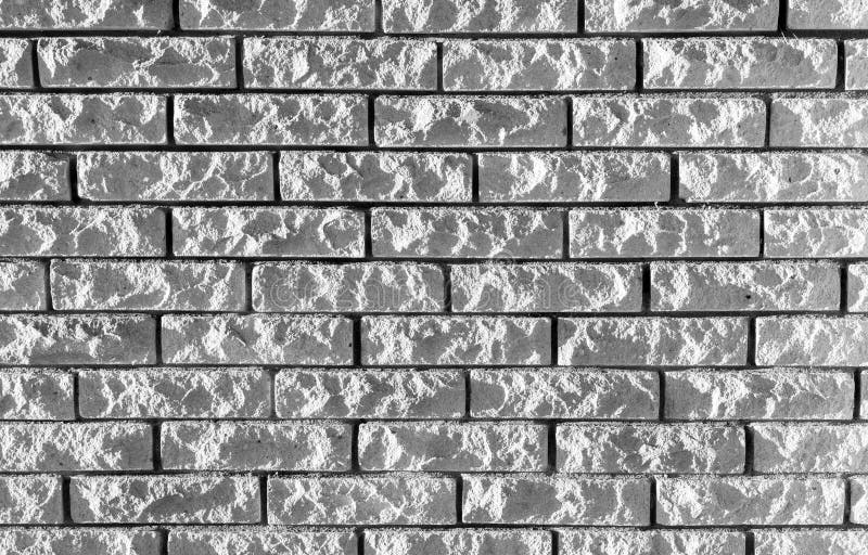 Background texture of gray rough brick wall front view black and white photo stock afbeelding