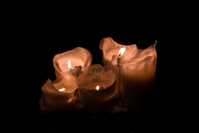 Large White Burning Candles in Dark Room Over Wall Background Stock