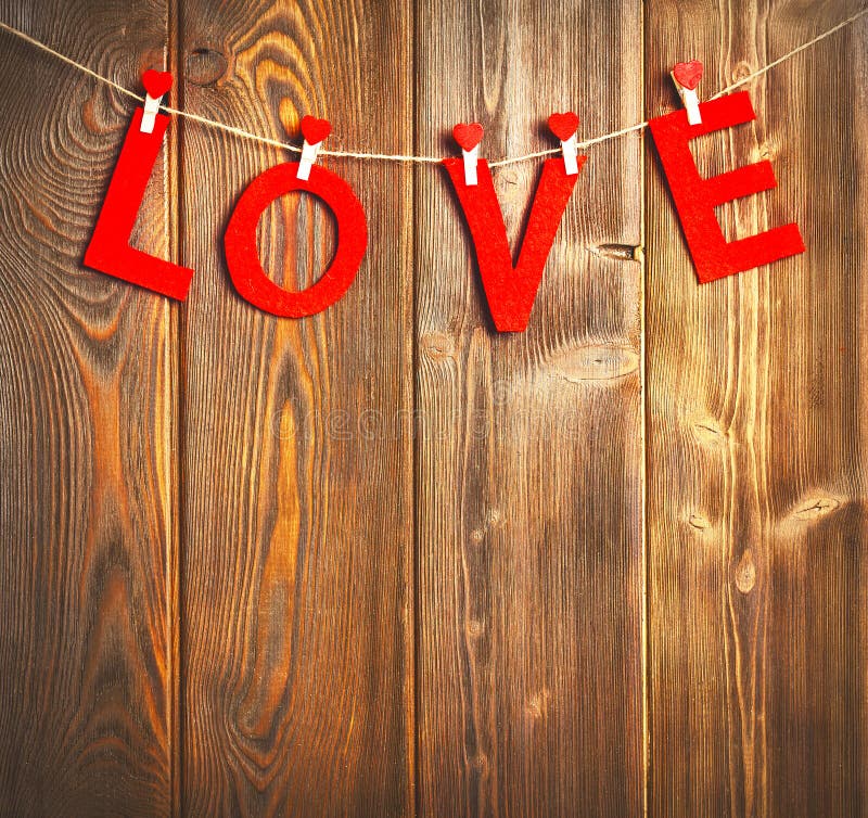 Background of Valentine`s Day. red hearts on a wooden background. Background of Valentine`s Day. red hearts on a wooden background