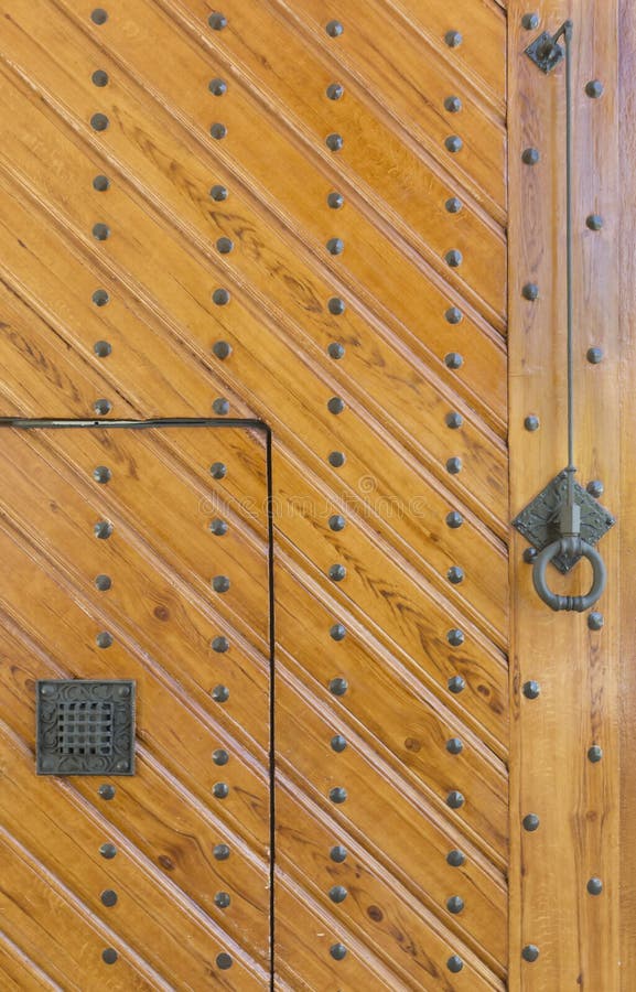 Wooden doors with rivets stock image. Image of design 185649959