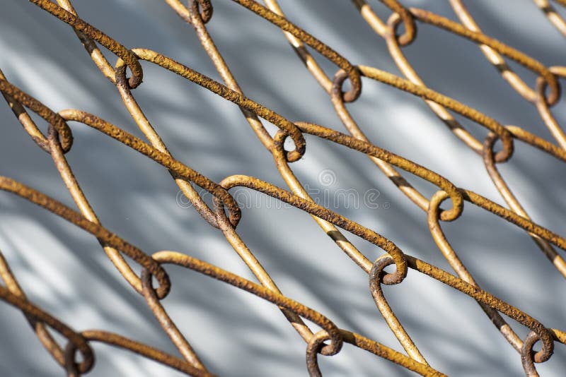 Background from a yellow metal mesh. The grid has rusty large cells royalty free stock photography
