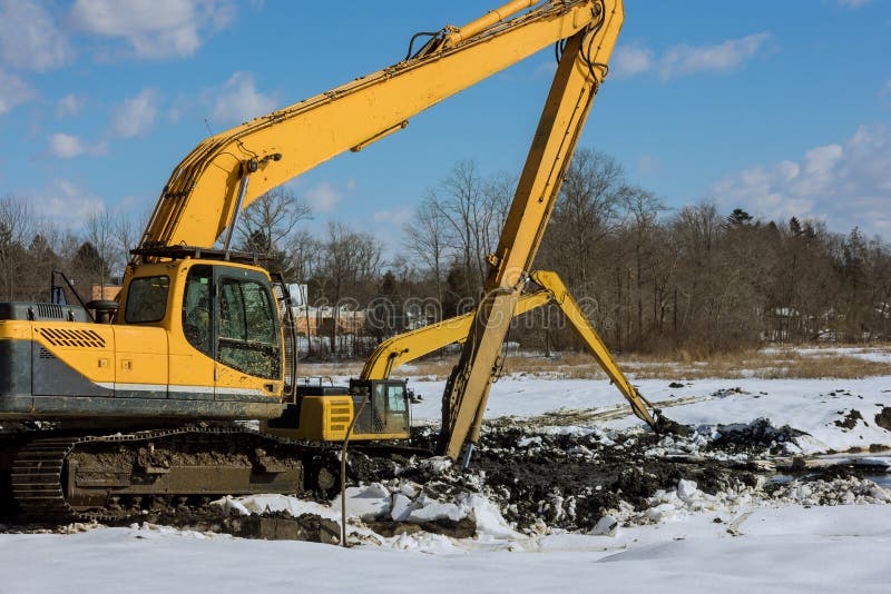 Backhoe Digging the Ground during Works at for Soil Construction Stock