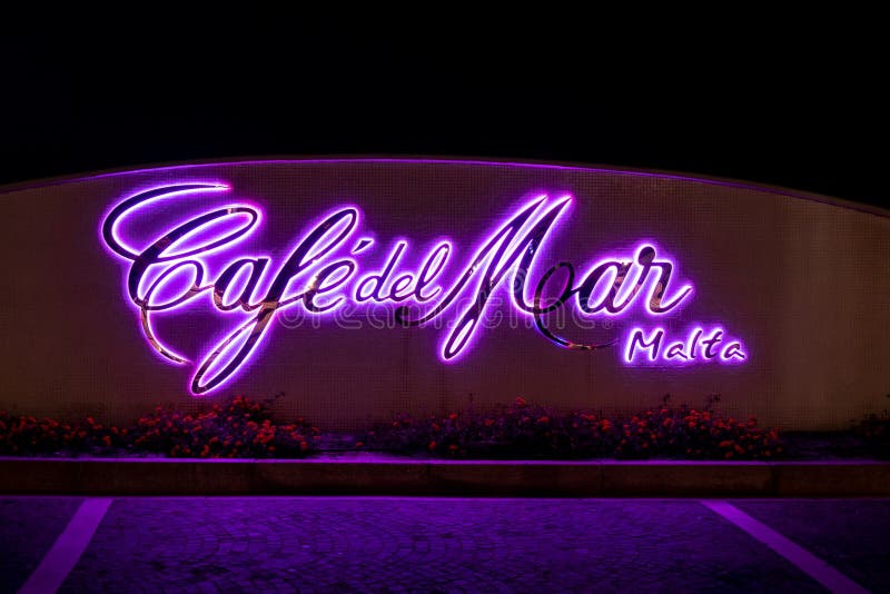 BUGIBBA, MALTA - OCTOBER 26, 2019: The backlighted logo of the Cafe del Mar in St Pauls Bay, Bugibba at night near the complex of Malta National Aquarium