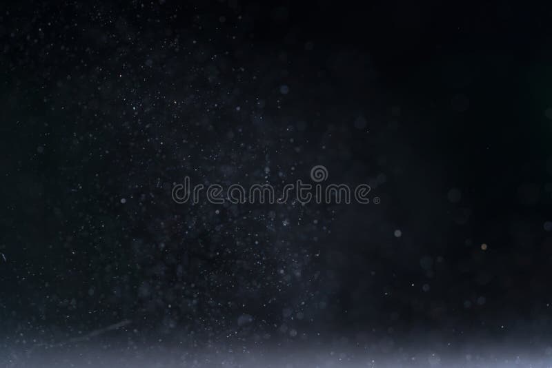 Backlit real dust particles with lens flare, abstract background. Backlit real dust particles with lens flare, abstract background