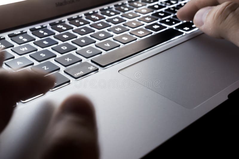 Backlit keyboard and touchpad with hands stock photos