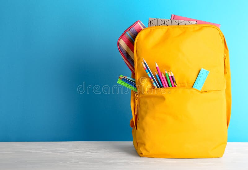 Backpack with different colorful stationery royalty free stock image