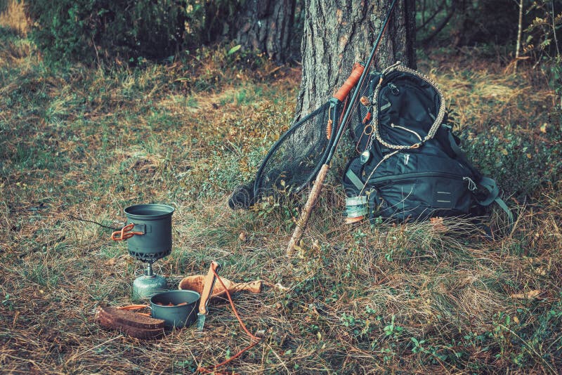 Backpack and Fishing Rod on the River. Fishing Gear Stock Photo Image