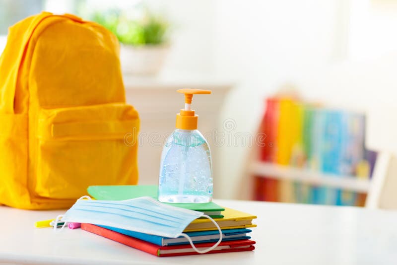 Backpack of school child. Face mask and sanitizer stock images