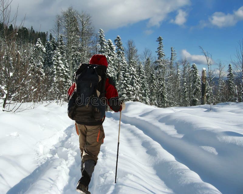 Backpacker going up of winter