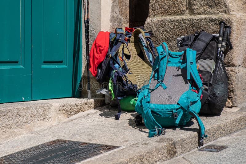 Backpacks Piled Up at the Door of a Pilgrims Hostel on the Camino De Backpacks Piled Up at the Door of a Pilgrims Hostel on the Camino De