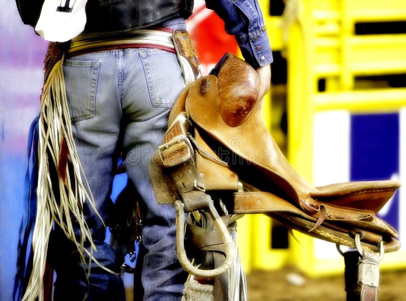 Backside of a Rodeo Cowboy with his Saddle