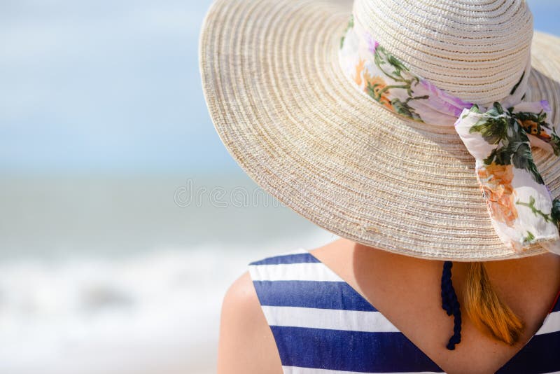 Backview of elegant young woman in straw hat on stock image Backview of elegant young woman in straw hat on stock image