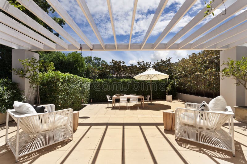 Backyard cozy patio area with wicker furniture set stock photos Backyard cozy patio area with wicker furniture set stock photos