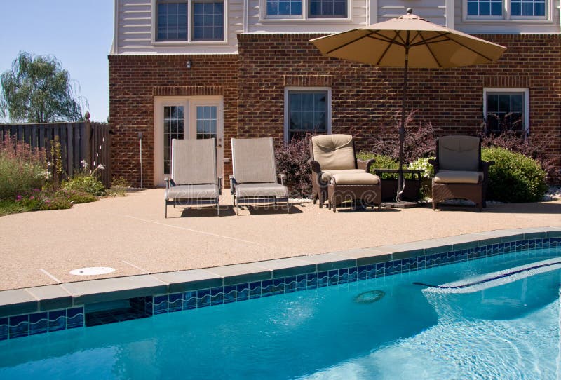 Backyard Pool with seats and umbrella stock photos