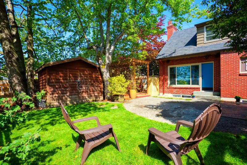 Backyard View with Concrete Patio and Small Shed. Stock Photo Image