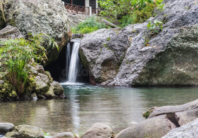 Little waterfall at a peaceful spa called Serendipity in Kingston, Jamaica. Man made waterfall stock images, royalty-free photos and pictures