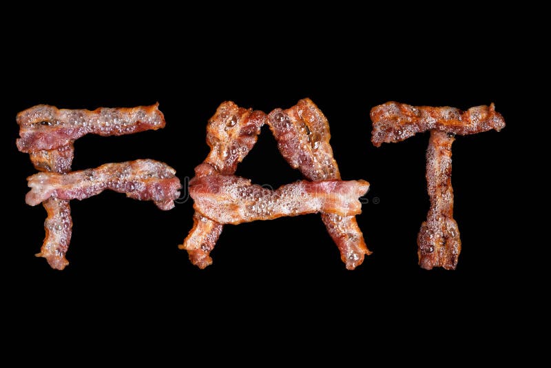 Bacon shaped as the word FAT on black background hot tasty crispy. Bacon shaped as the word FAT on black background hot tasty crispy